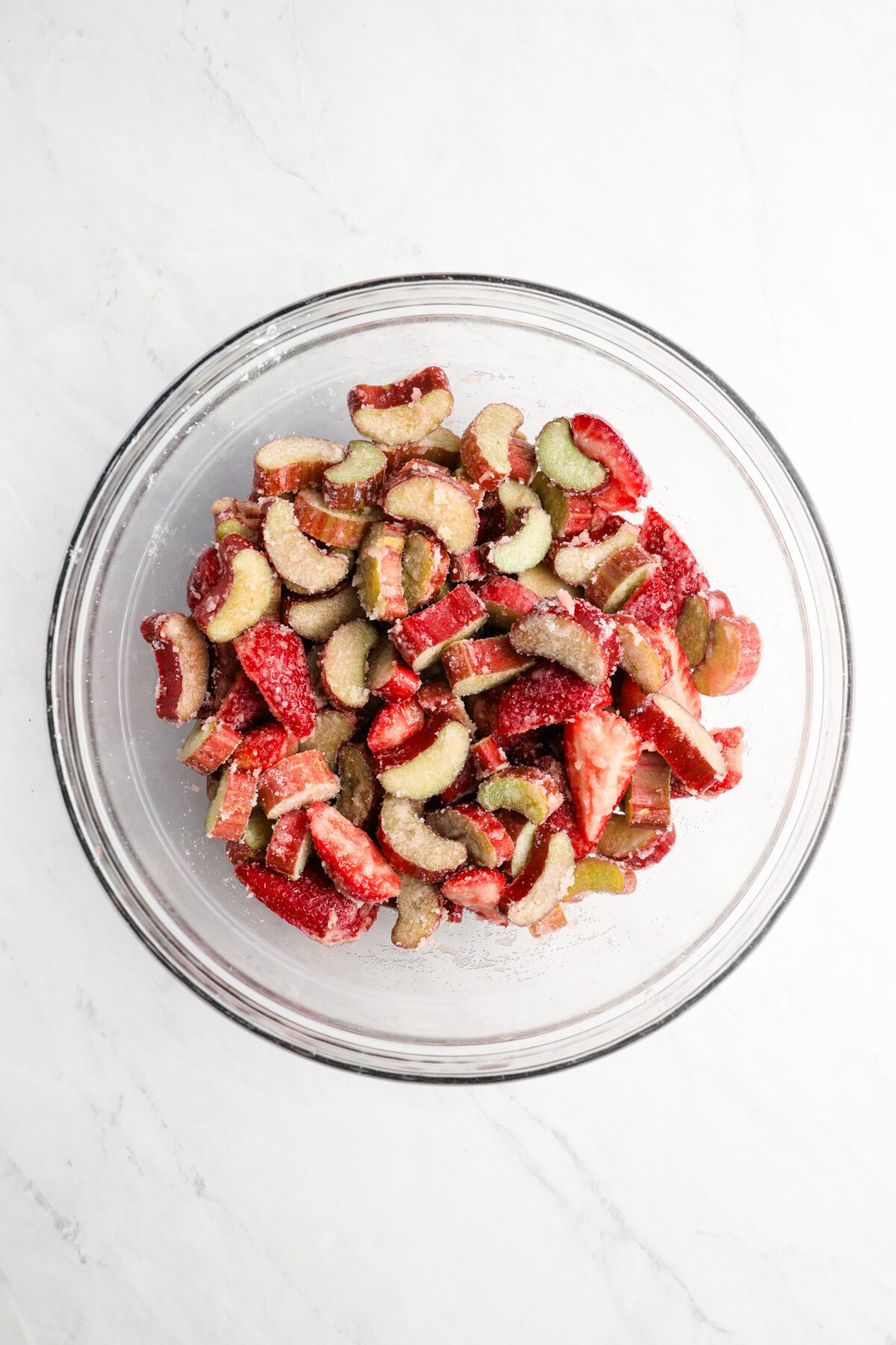 strawberry and rhubarb mixed with filling ingredients in bowl