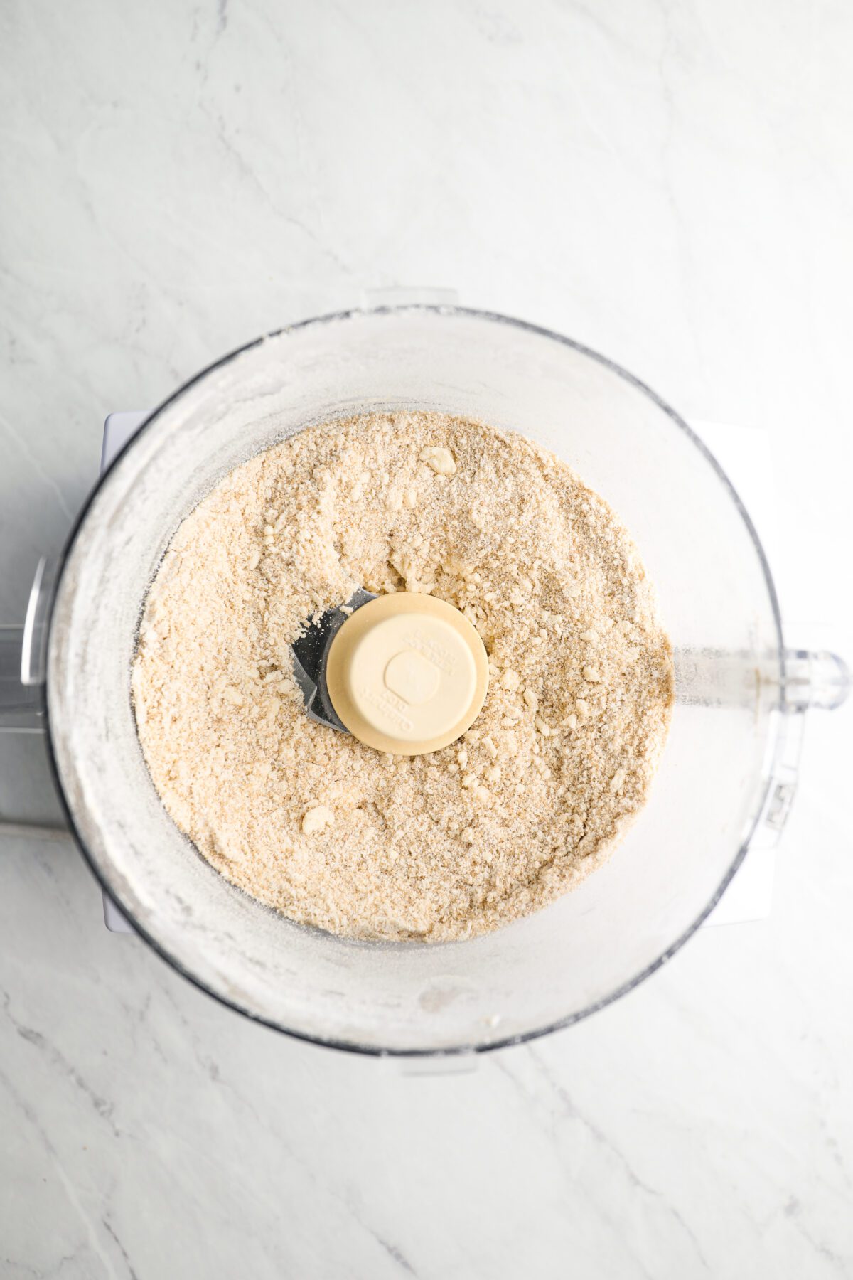 butter cut into dry ingredients in bowl of food processor