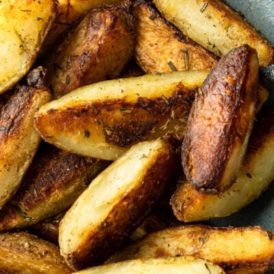 crispy baked potato wedges in gray bowl