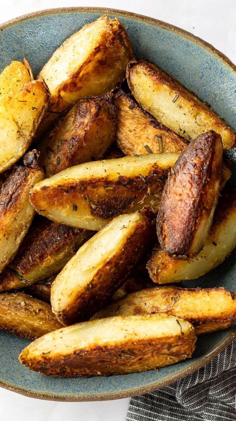crispy baked potato wedges in gray bowl