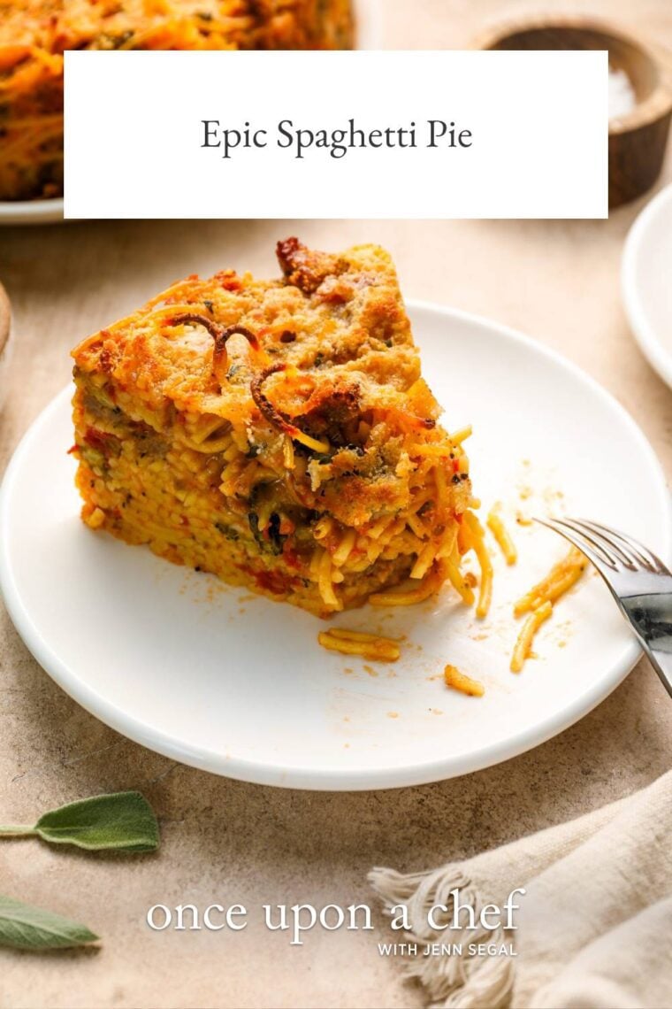 white plate with fork and slice of spaghetti pie
