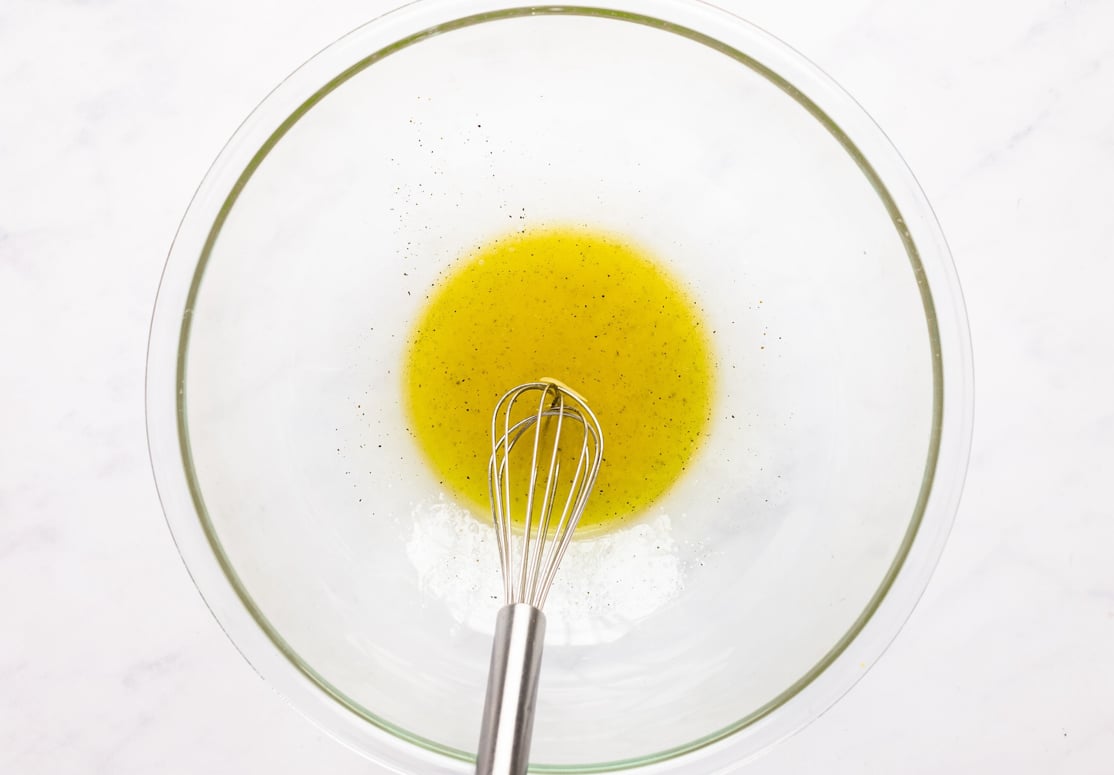lemon dressing whisked in bowl