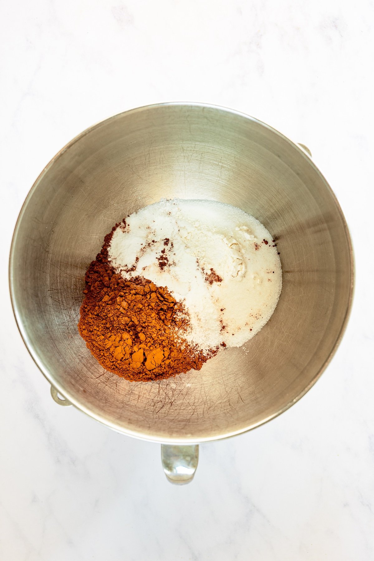 mixing bowl with flour, sugar, cocoa powder, salt, baking powder, and baking soda