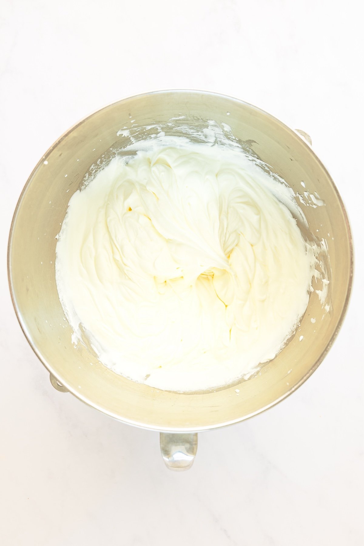 mixing bowl with confectioners' sugar and heavy cream whipped to medium-stiff peaks