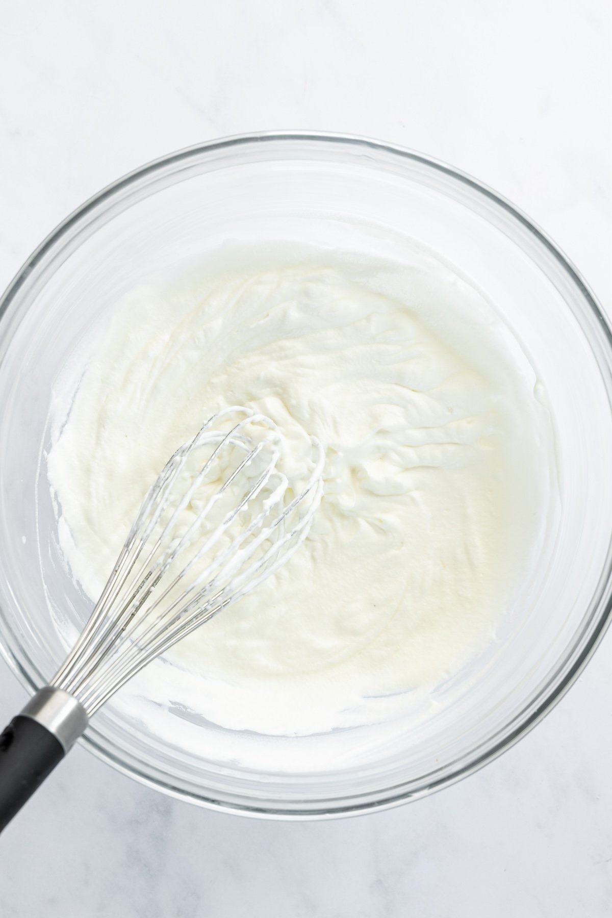 medium bowl with heavy cream whipped to stiff peaks