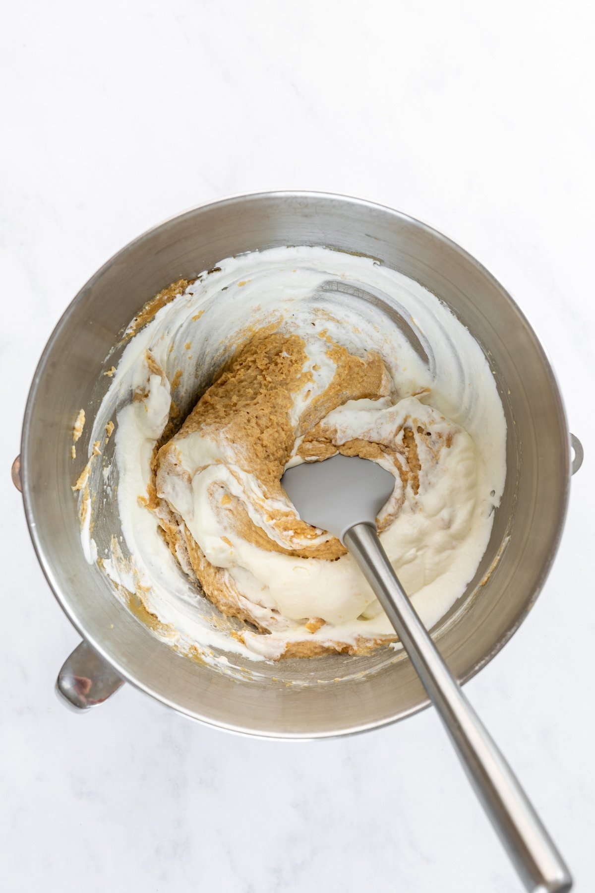 folding the peanut butter base and whipped cream together in mixing bowl