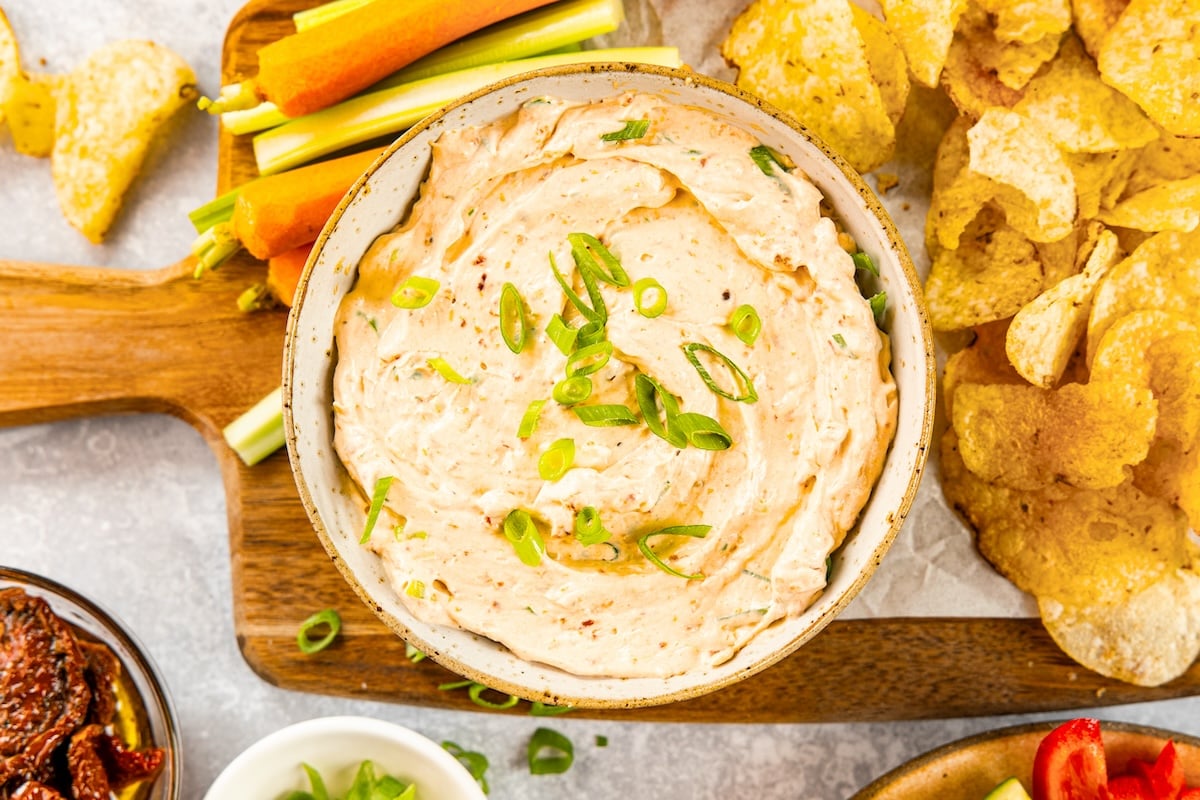 sun-dried tomato dip with potato chips and crudites