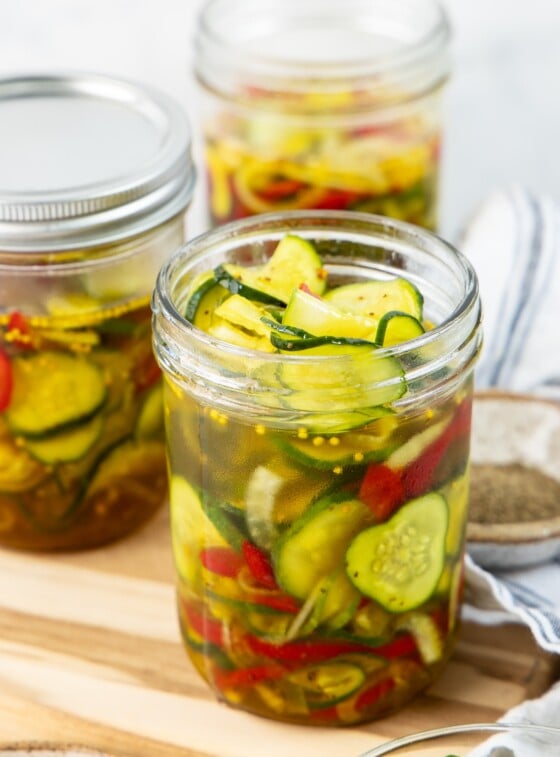 3 jars filled with bread and butter pickles