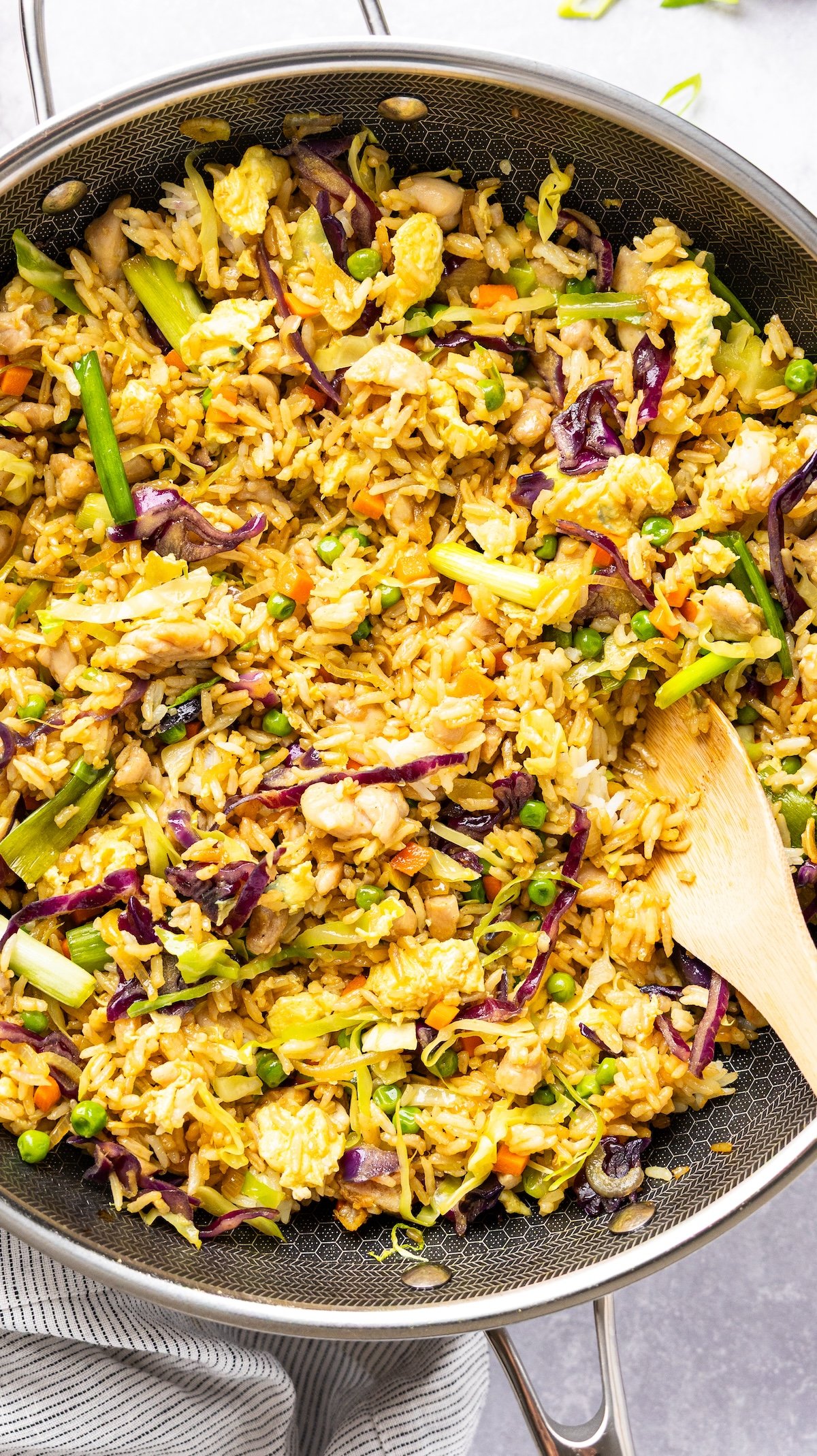 nasi goreng in skillet with wooden spoon