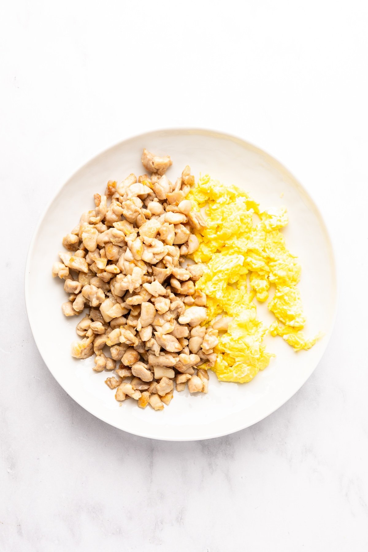 cooked chicken and eggs on white plate