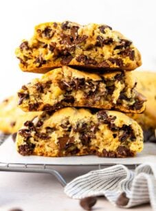 levain chocolate chip cookies stacked on cooling rack