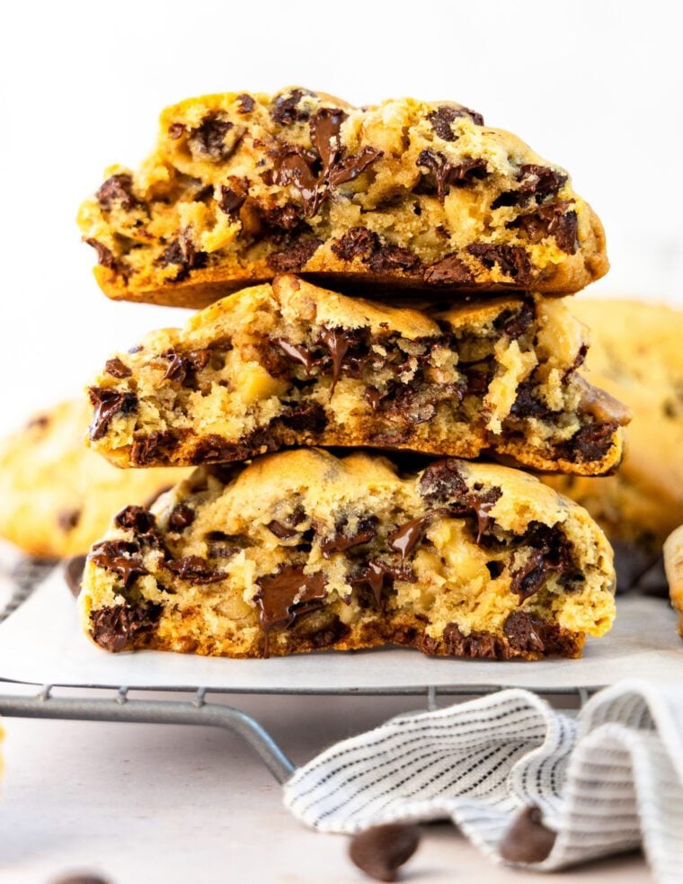 levain chocolate chip cookies stacked on cooling rack