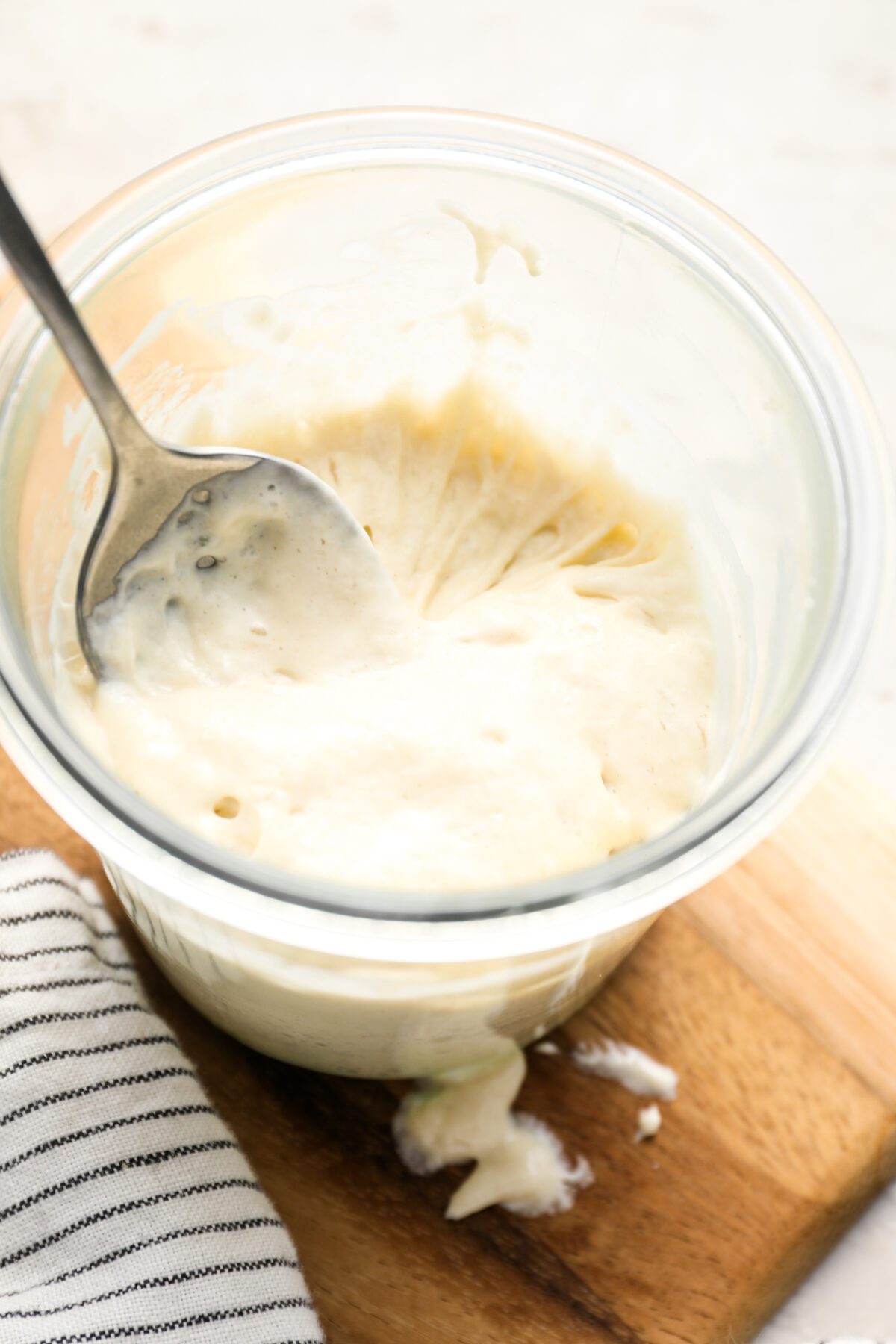 stretchy sourdough starter in jar with spoon