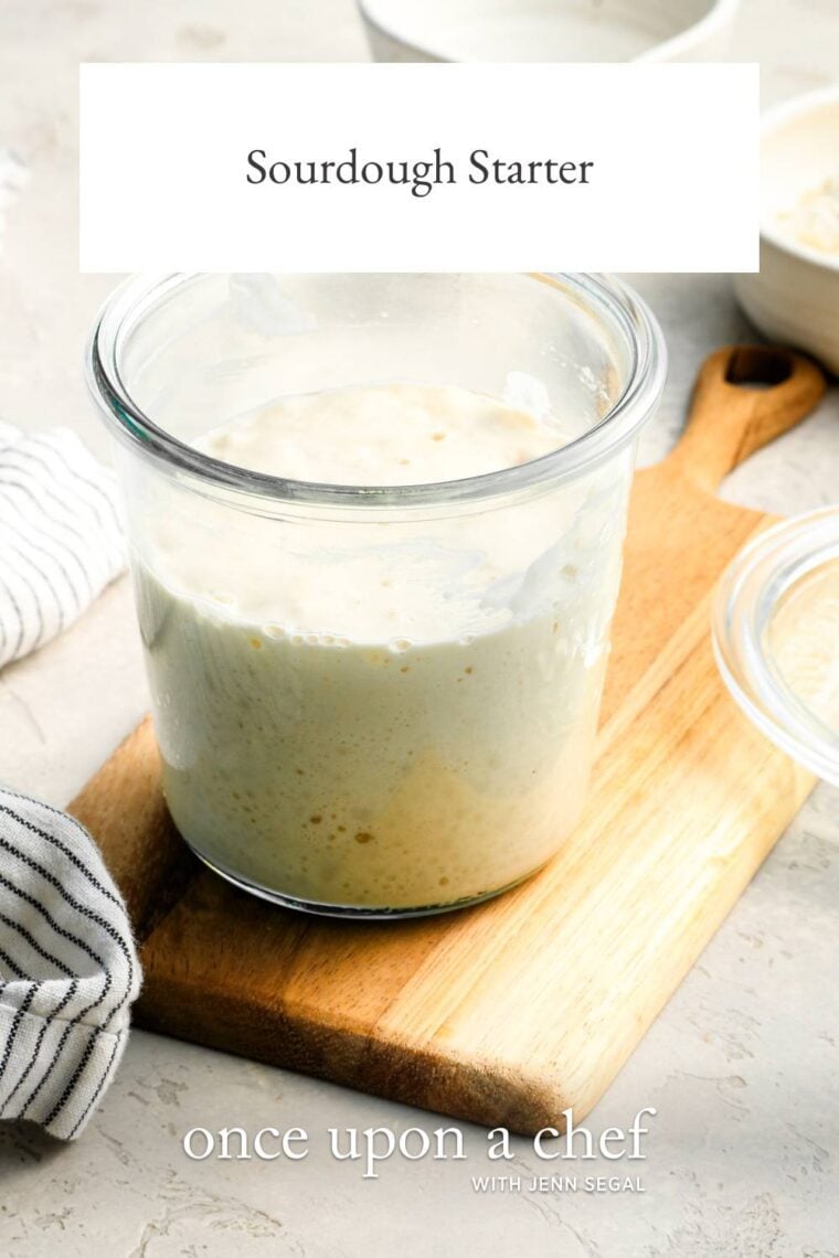 sourdough starter in a jar sitting on a cutting board