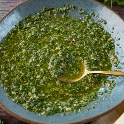 Chimichurri sauce in blue bowl.