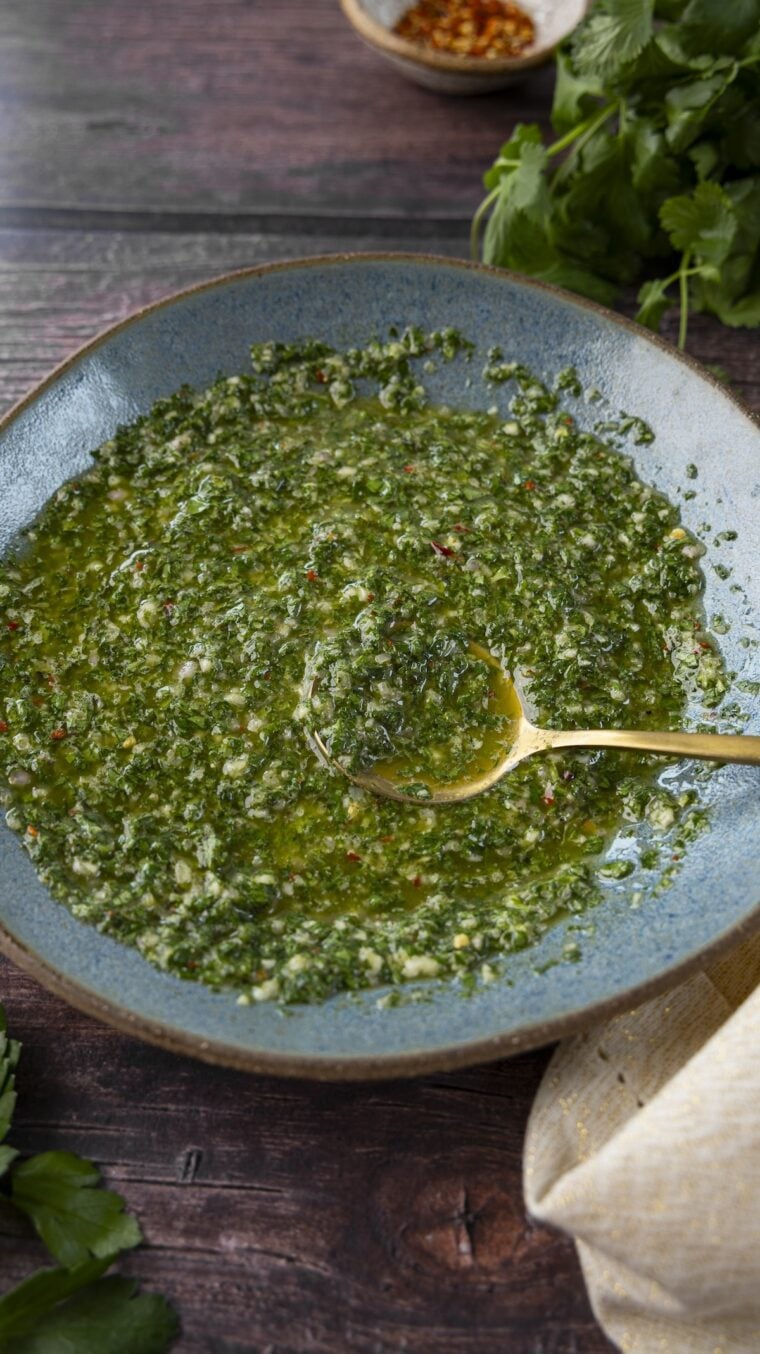 Chimichurri sauce in blue bowl.