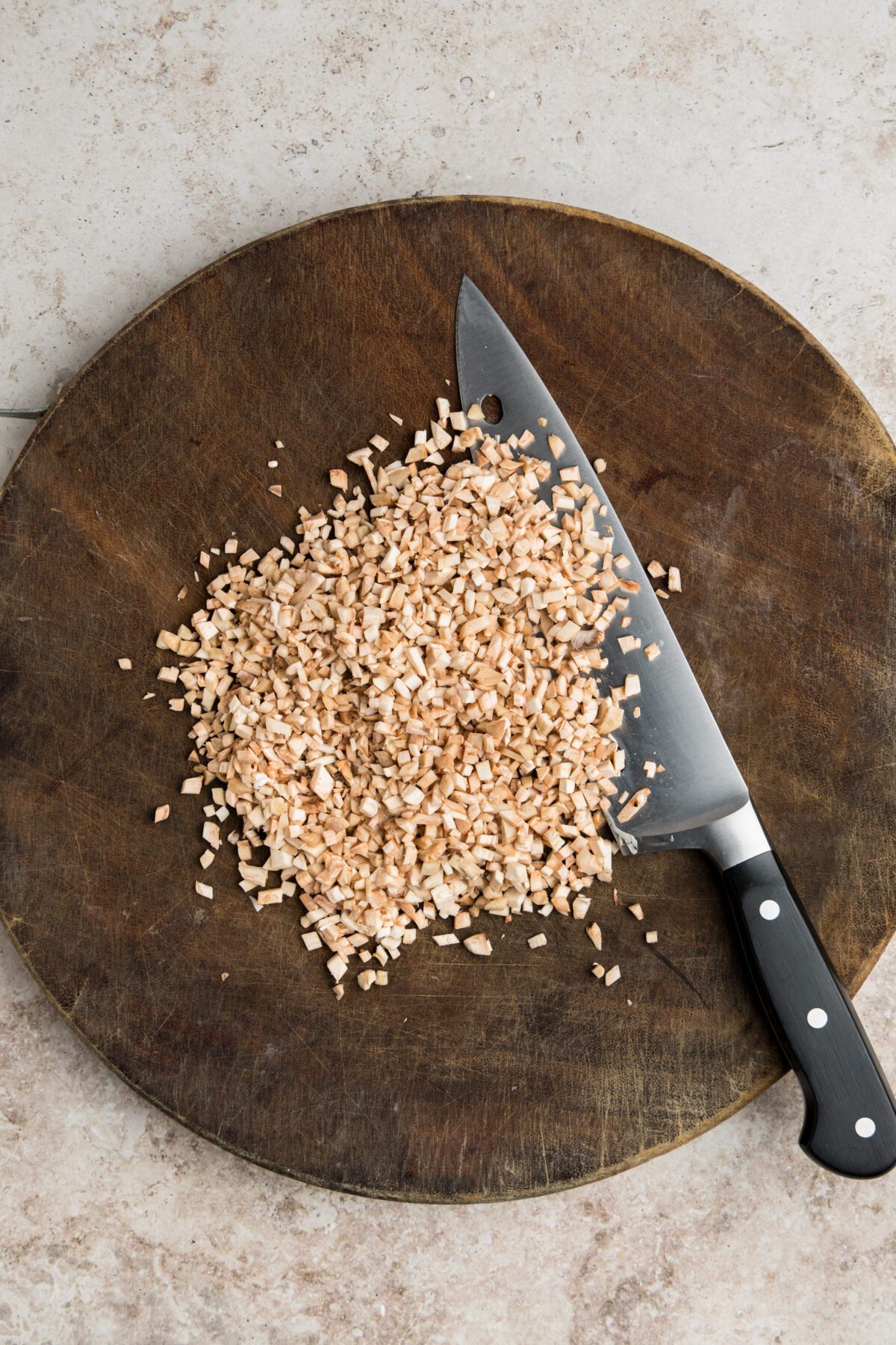 cutting board with finely chopped mushroom stems