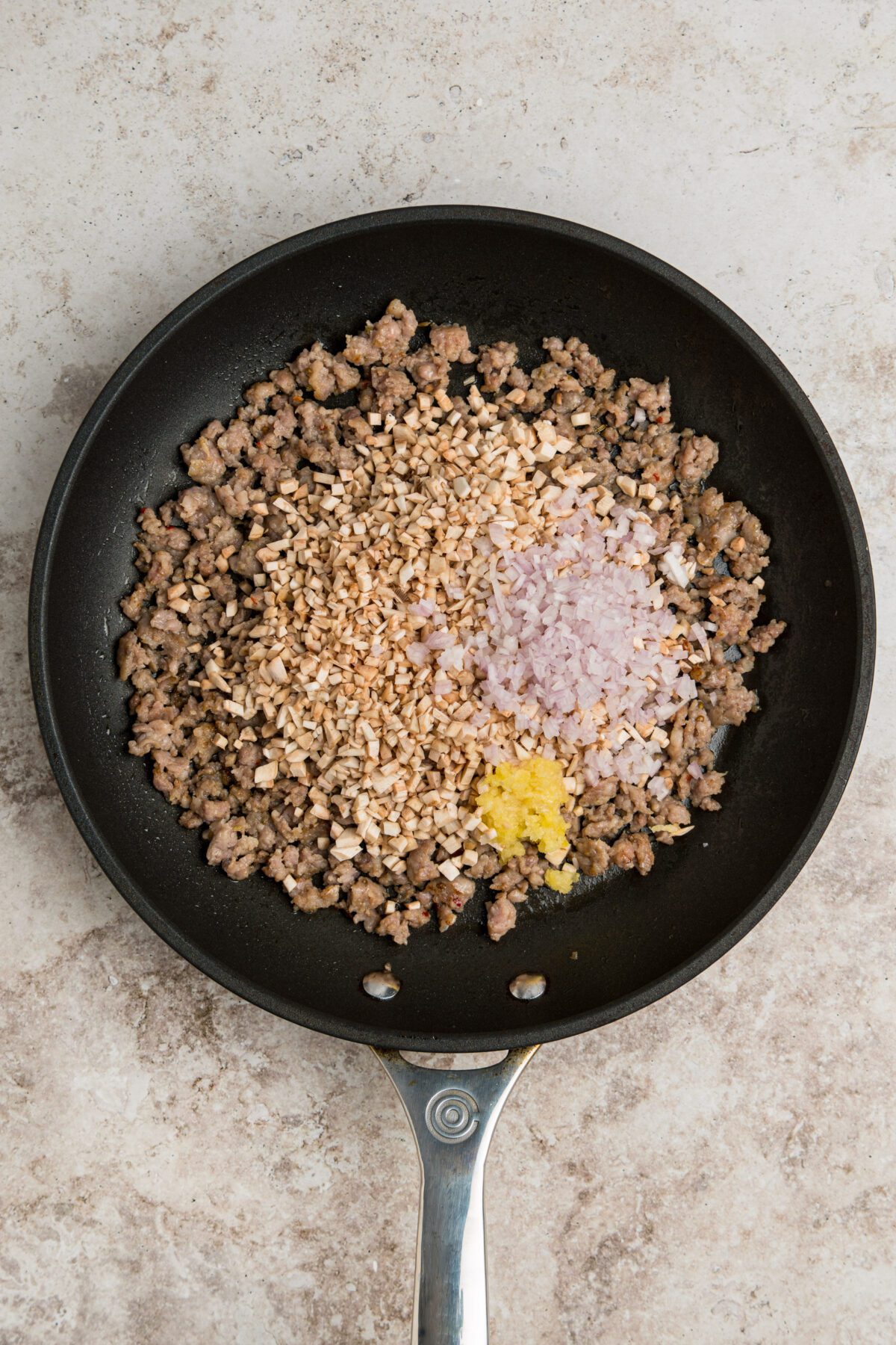 browned sausage and aromatics in skillet