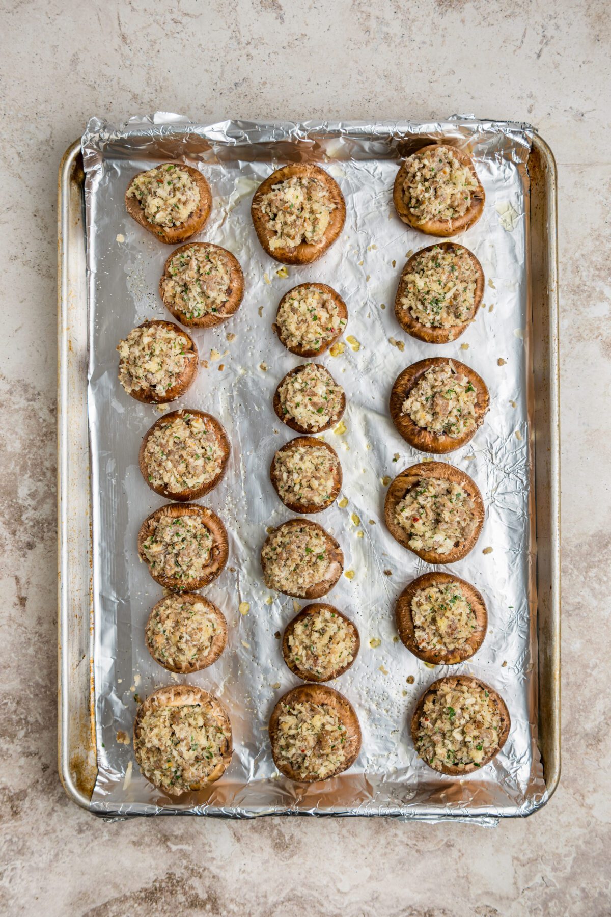 unbaked stuffed mushrooms on baking sheet