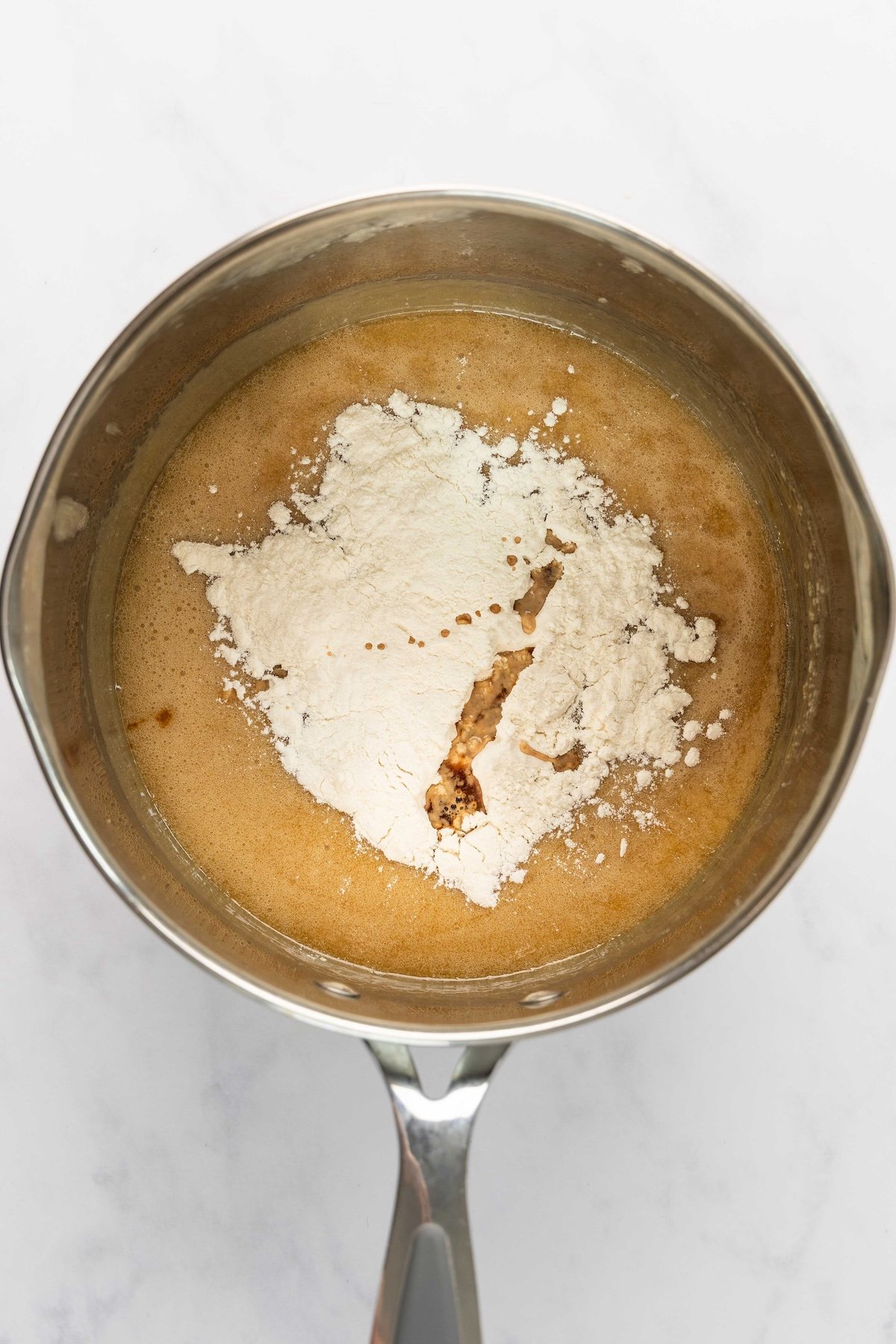 flour and vanilla added to butter, brown sugar, corn syrup, and salt mixture