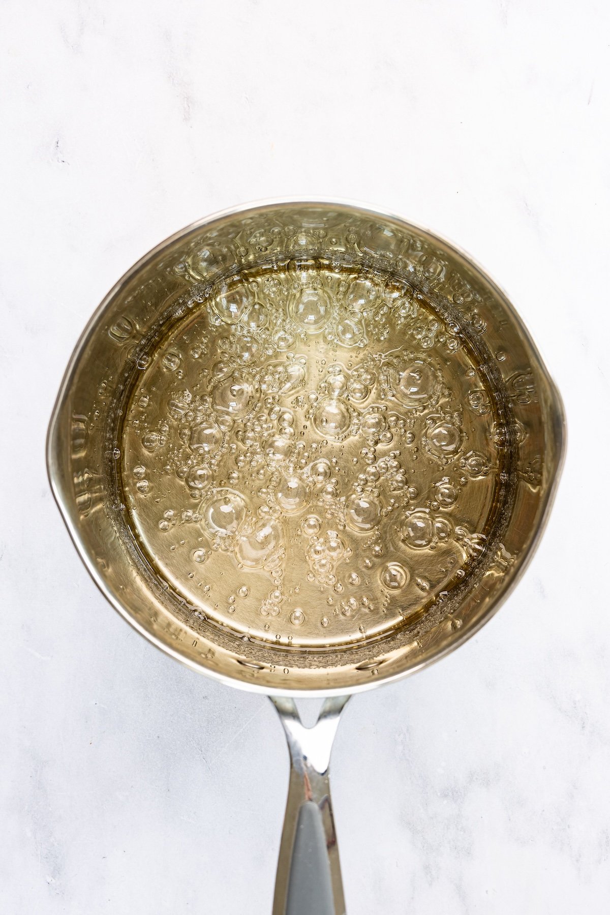 medium saucepan with boiling sugar, corn syrup, water, and salt mixture