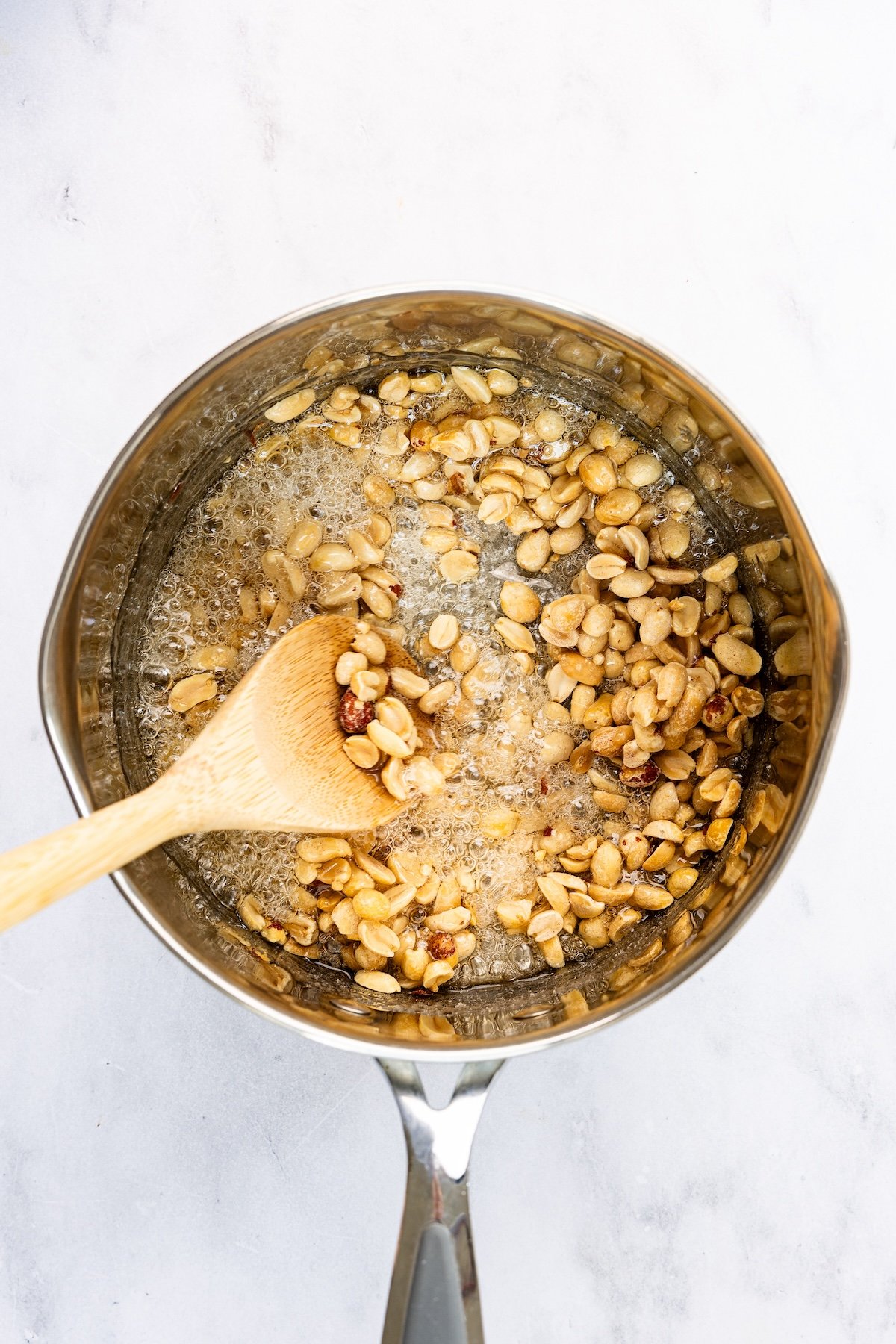 medium saucepan with peanuts added to sugar/corn syrup mixture