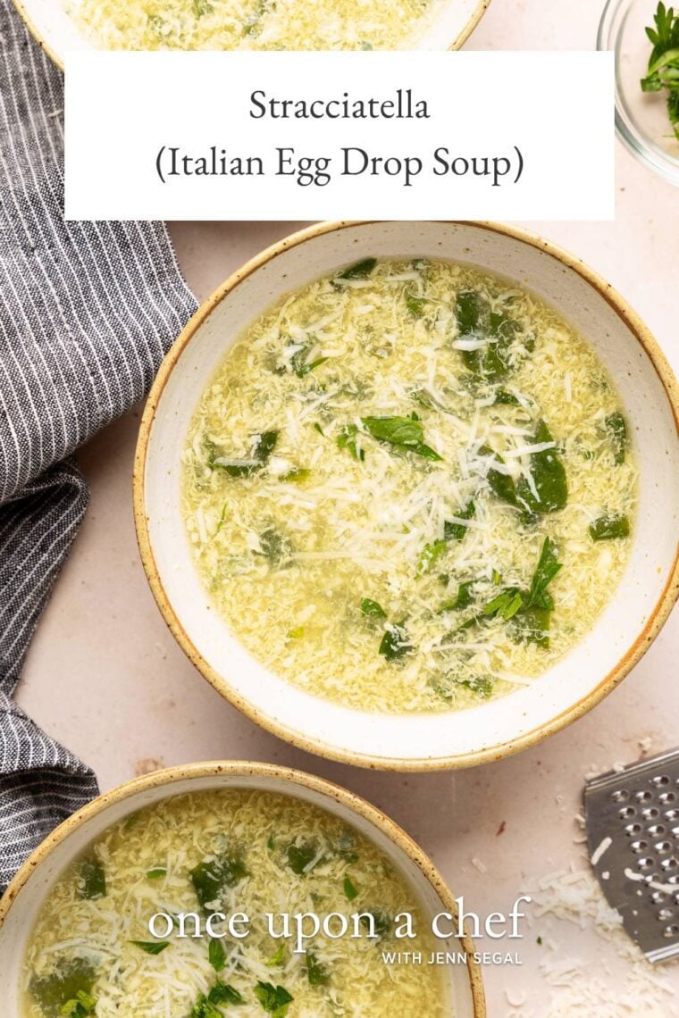 3 bowls of stracciatella soup with grated parmigiano reggiano on top