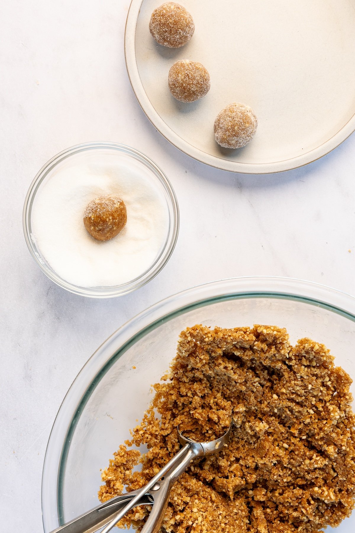 rolling 1-inch rum balls in small bowl granulated sugar