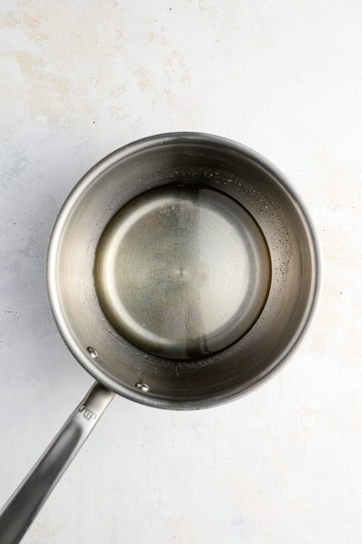 small saucepan with sugar and water