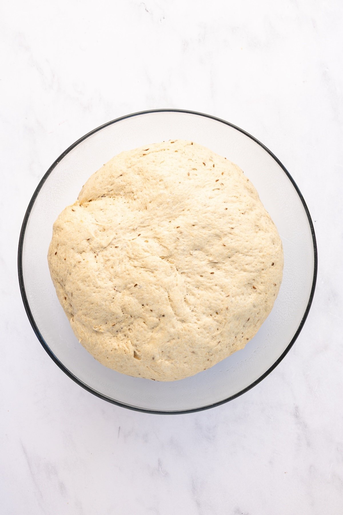 glass bowl with risen rye bread dough