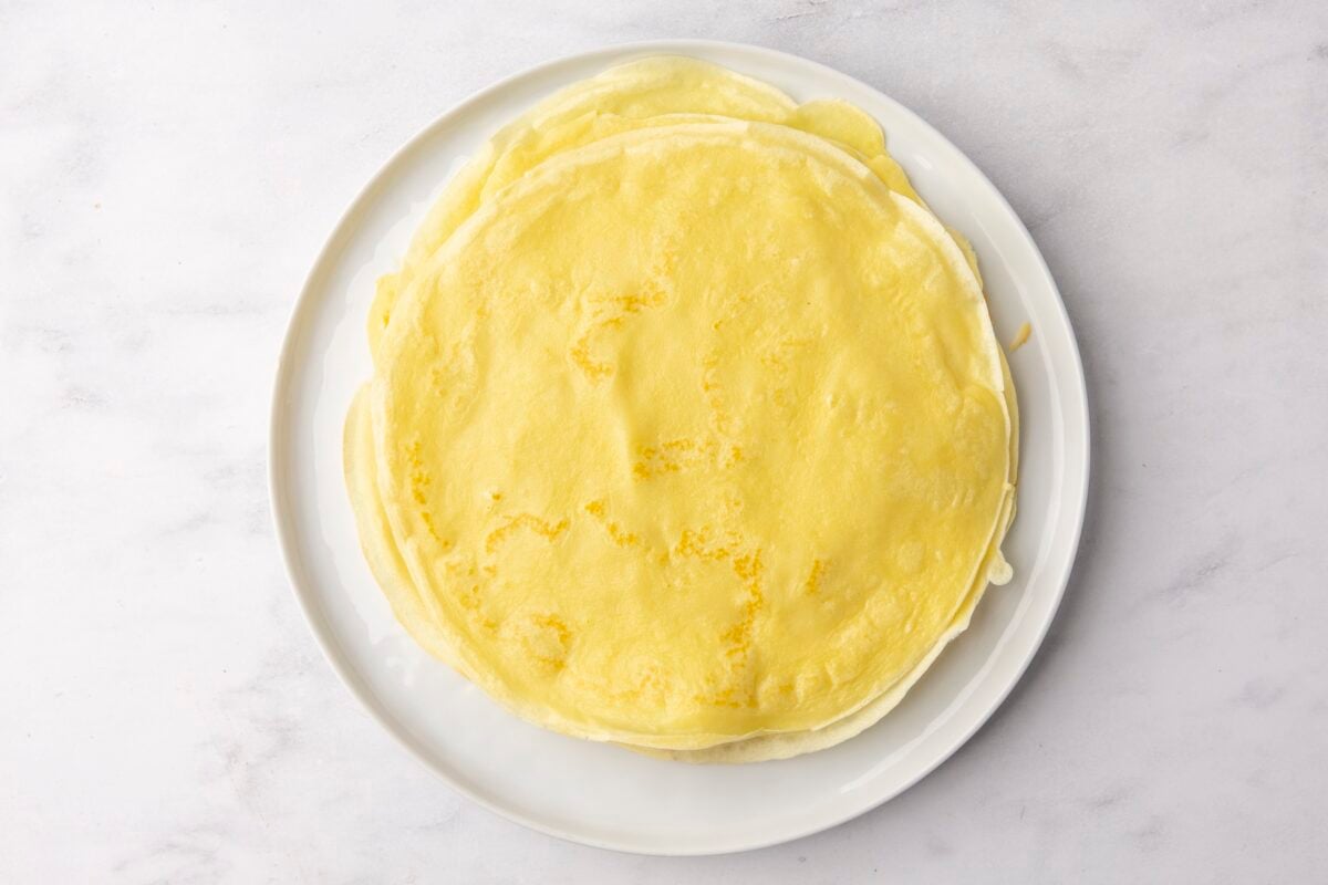 stack of cooked crepes on white plate