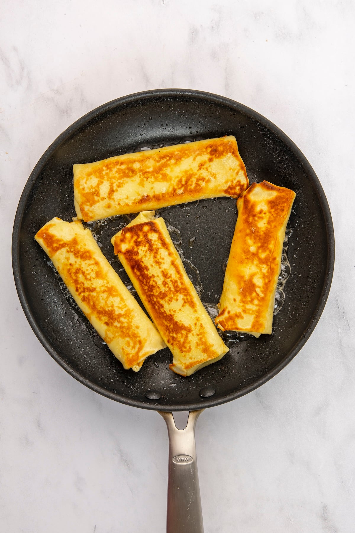 cooking flip side of blintzes in nonstick skillet