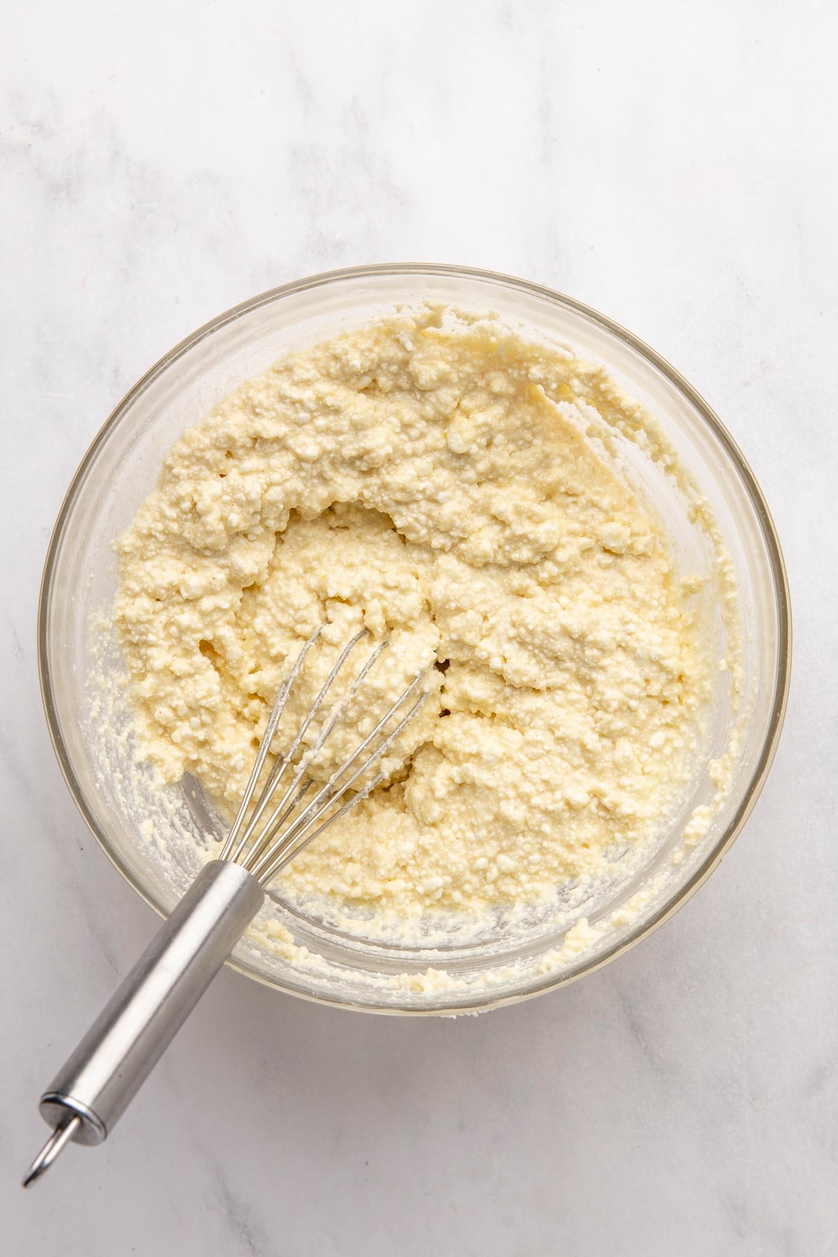 medium bowl with armer’s cheese, egg, sugar, salt, cinnamon, vanilla, and melted butter combined together