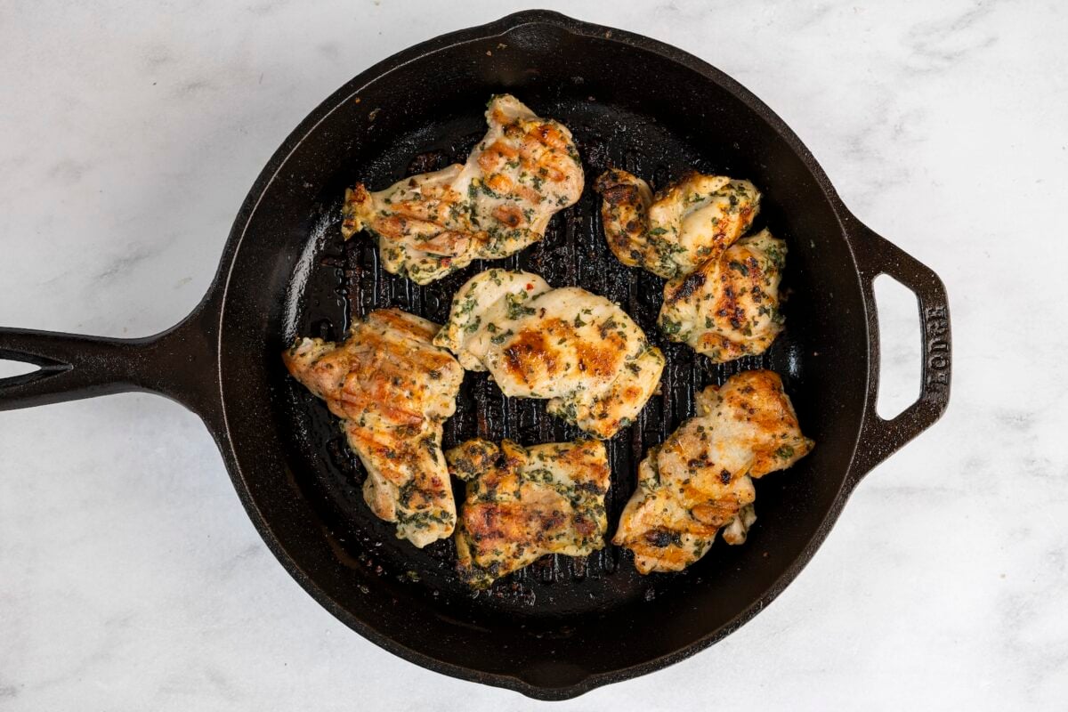 chicken thighs cooking in grill pan