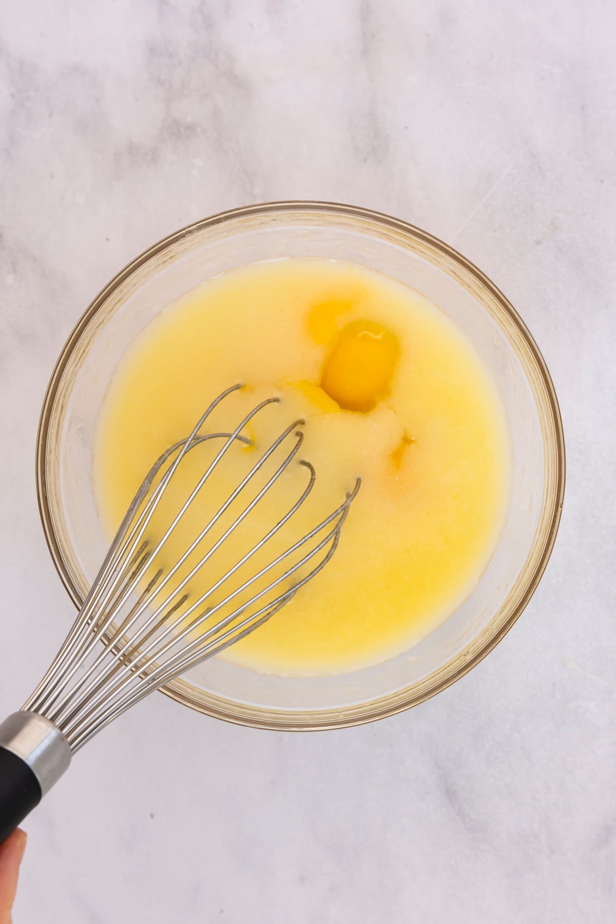 whisking wet ingredients in mixing bowl