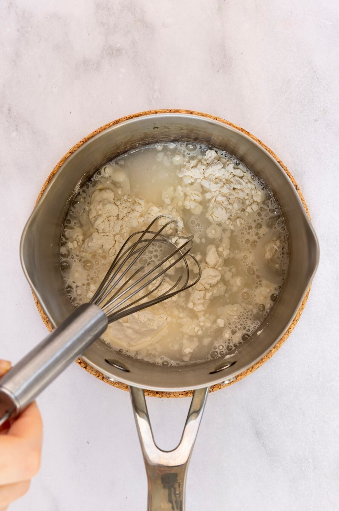 whisking water and flour