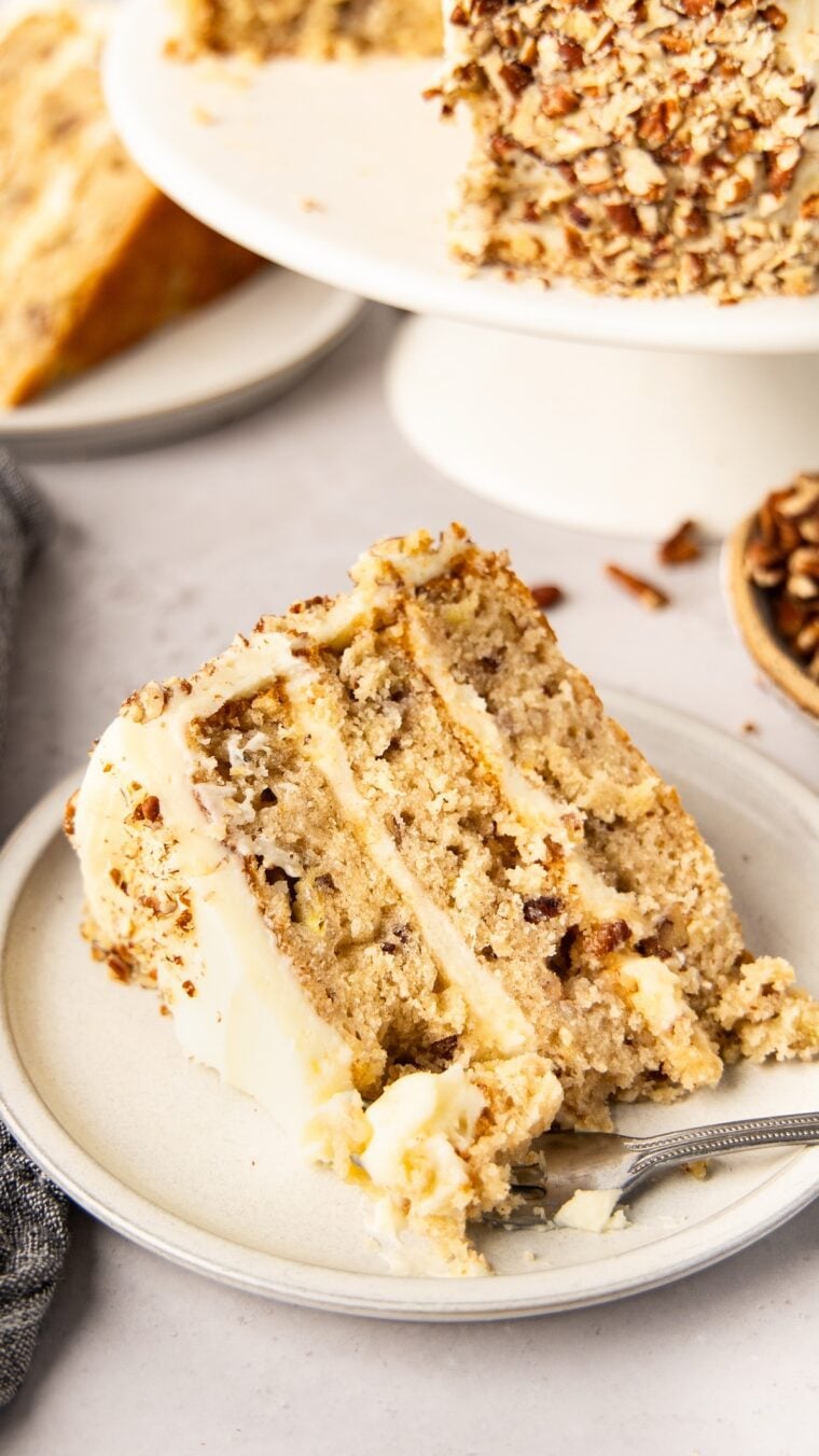 Slice of hummingbird cake on a white plate.