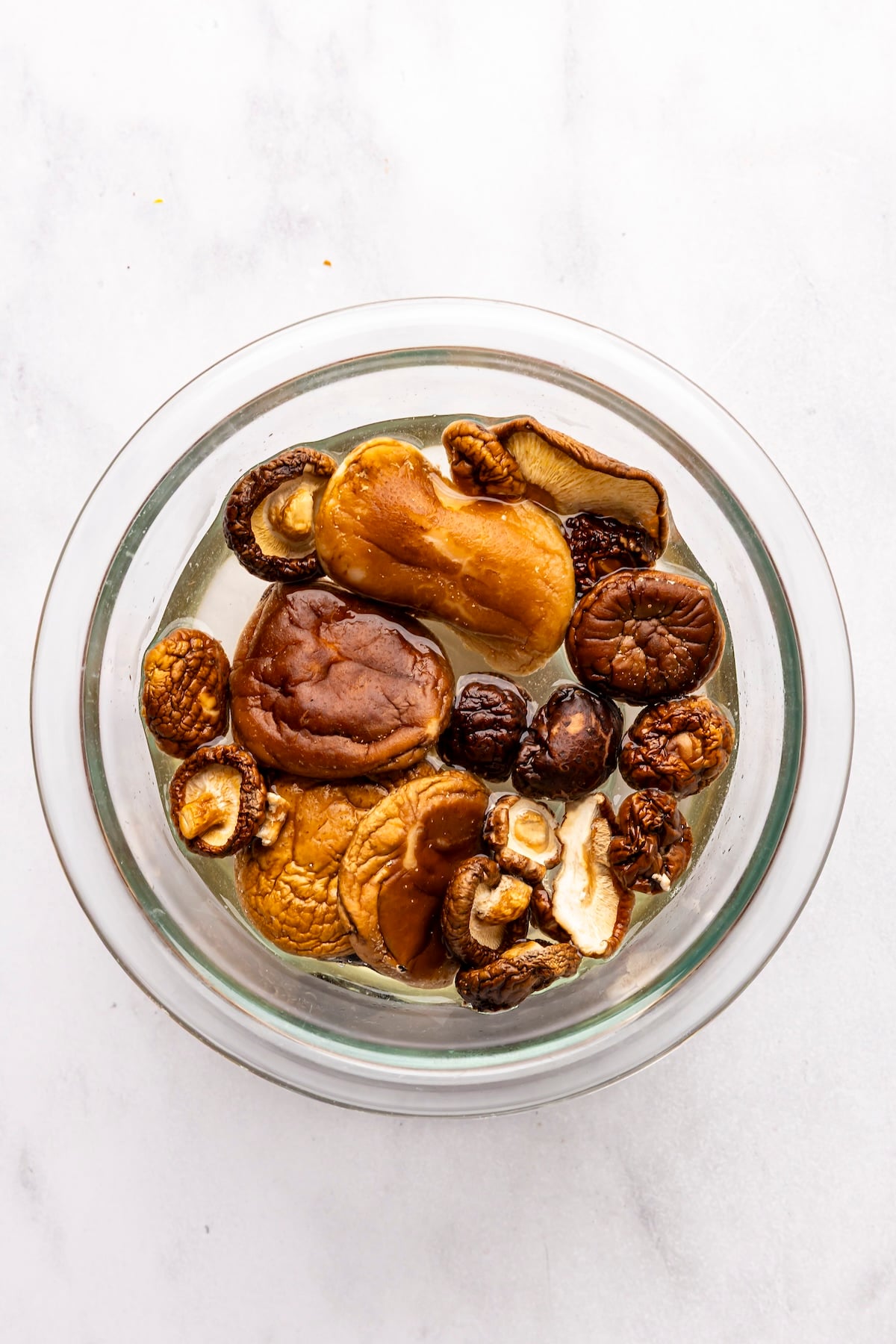 medium bowl with dried mushrooms rehydrating in very hot water