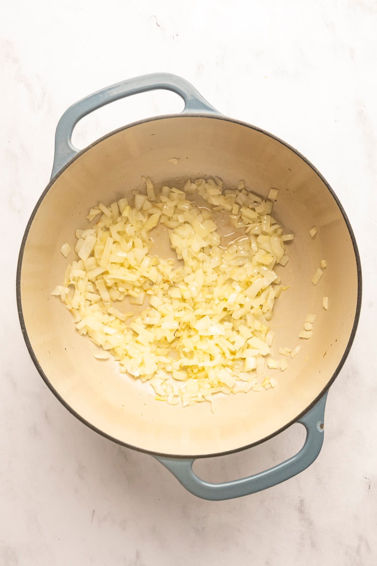 dutch oven with melted butter and diced onion