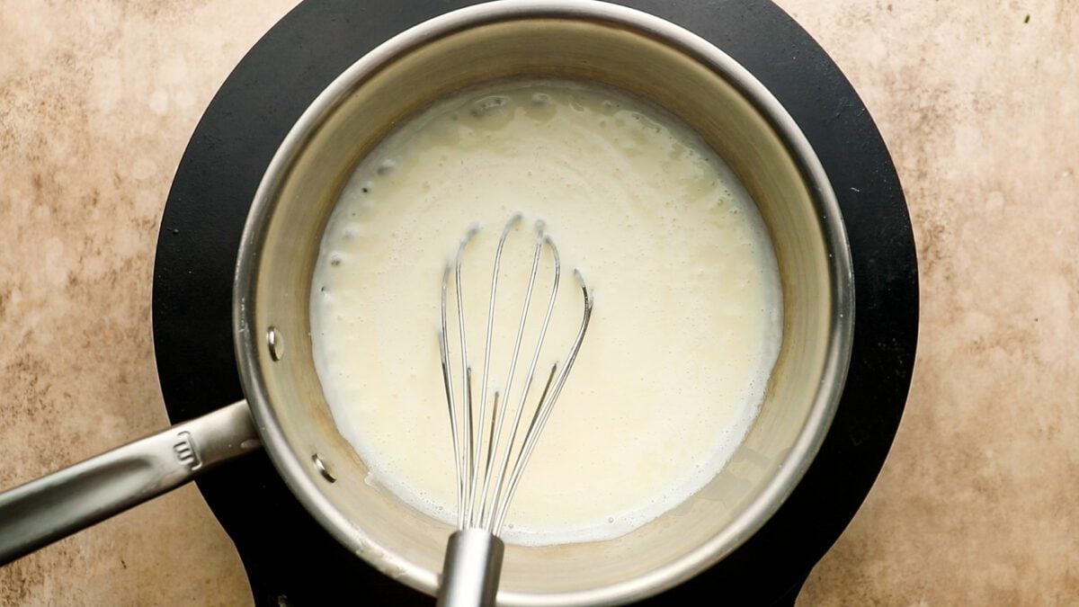 whisking milk into roux for bechamel sauce