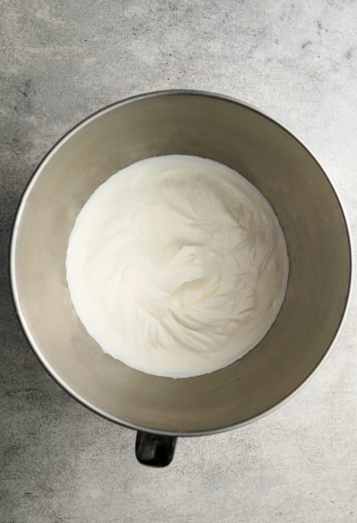 mixing bowl with heavy cream whipped to medium peaks