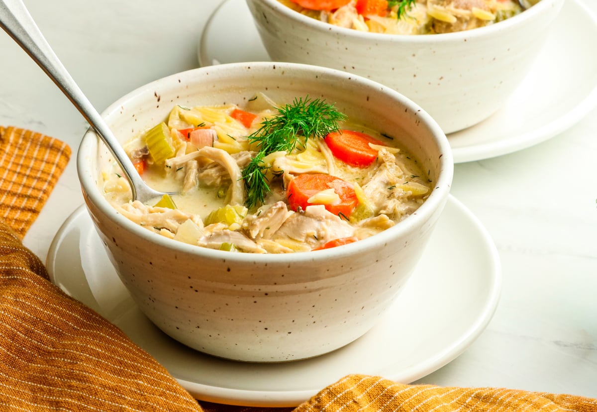 bowl of lemon chicken orzo soup with spoon