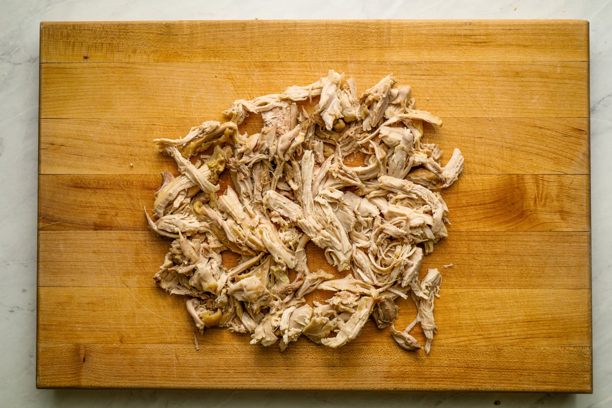 shredded chicken on cutting board
