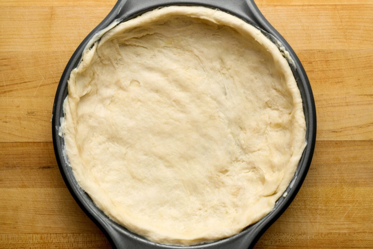 pizza dough pressed into pan