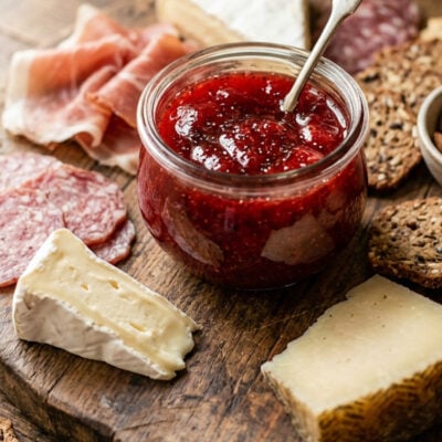 Jar of White Balsamic Strawberry Preserve with Black Pepper on charcuterie board