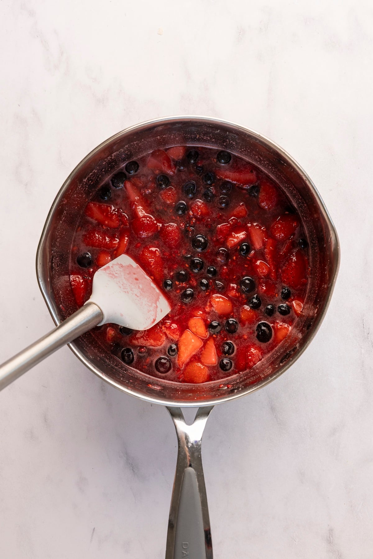 medium saucepan with cooked berry mixture 