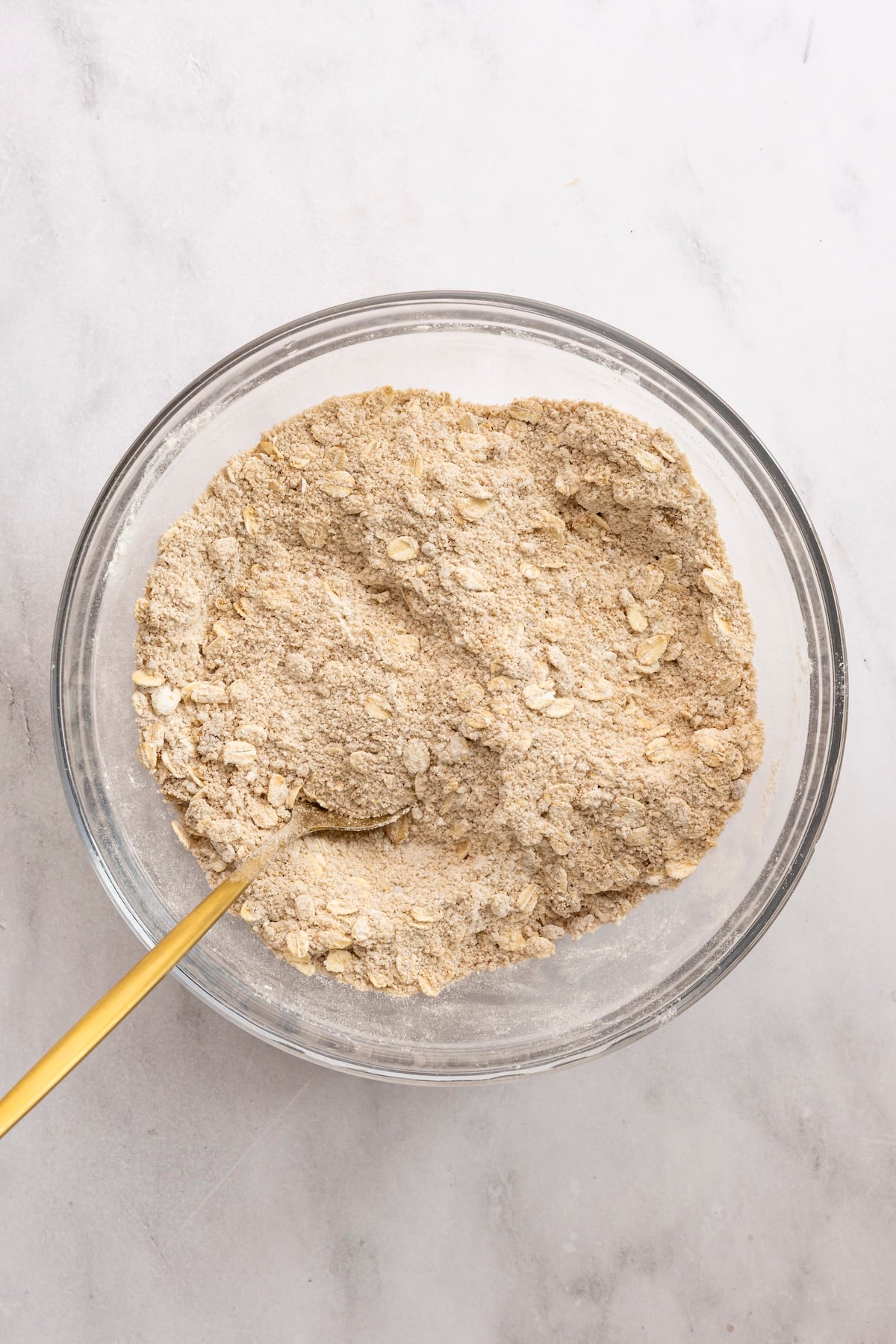 medium bowl with flour, oats, brown sugar, cinnamon, nutmeg, and salt combined