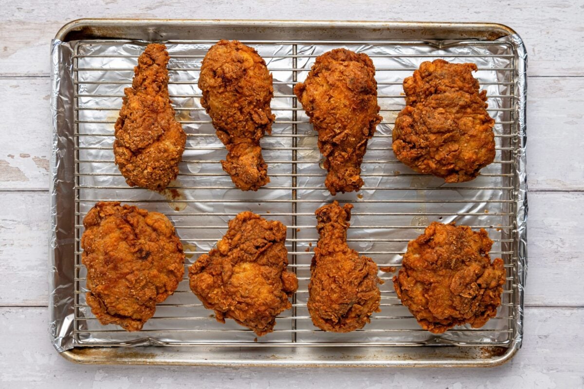 fried chicken on wire rack over foil-lined baking sheet