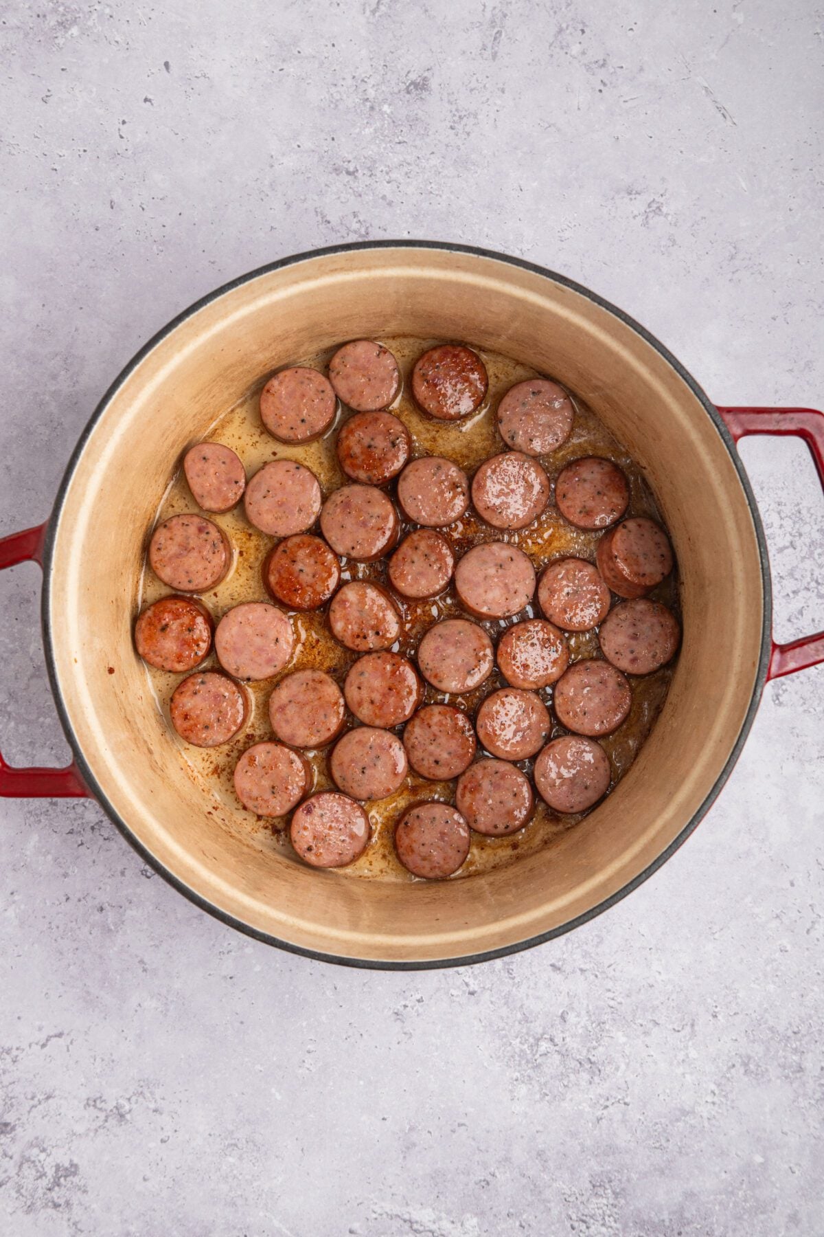 andouille sausage cooking in dutch oven