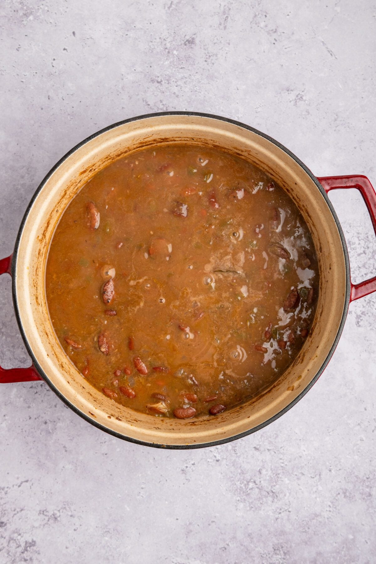 dutch oven with broth, vegetable and bean mixture reduced and thickened after cooking